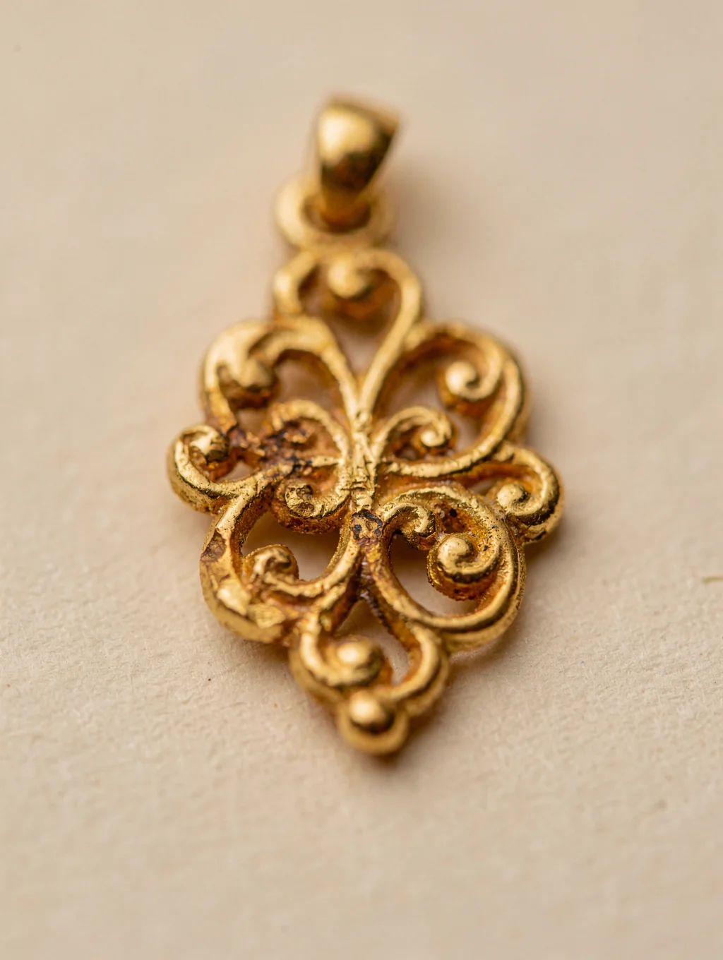 Handcrafted 18K gold pendant with organic hammered texture